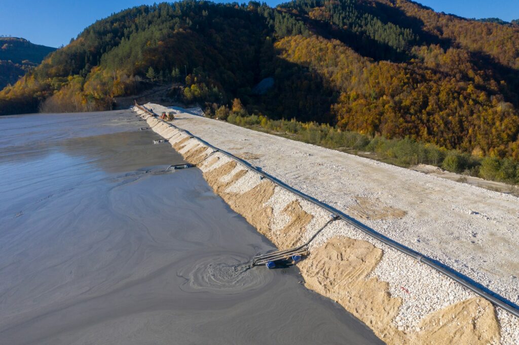 Aerial view of mining residual waters from a copper mine discharging into decanting pond