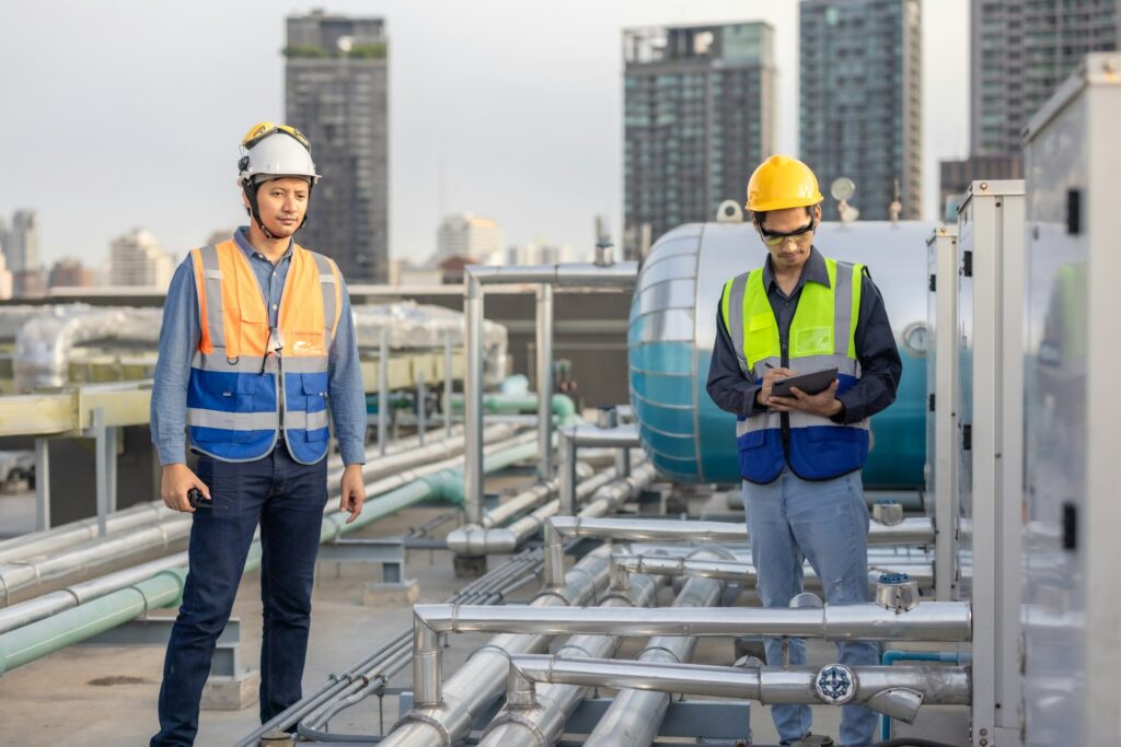 HVAC Engineer Coaching a Technician on Site During an Urban Maintenance Project