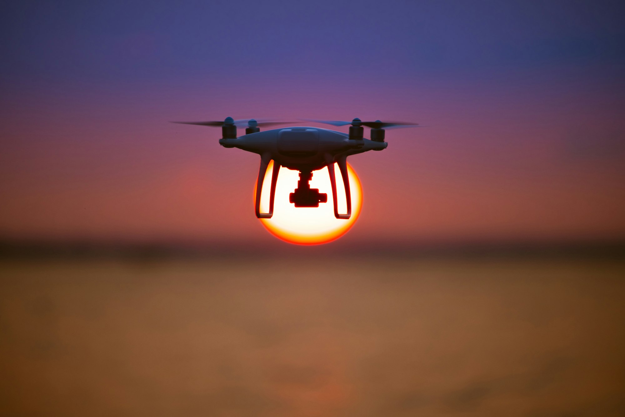 The drone flighting on the sunrise background