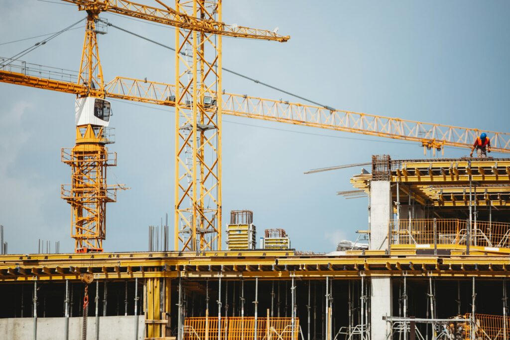 View of a construction site with buildings under construction and multi-storey residential homes.